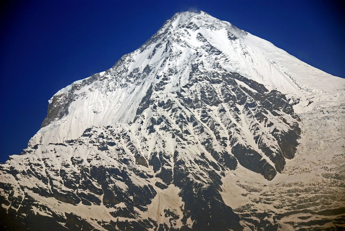 03 Pokhara Flight To Jomsom 03 Dhaulagiri Close Up Gyan and I took the early morning 17-minute flight from Pokhara to Jomsom. Dhaulagiri South and East faces shone perfectly in the early morning light as the airplane banked right to go up the Kali Gandaki Valley towards Jomsom.